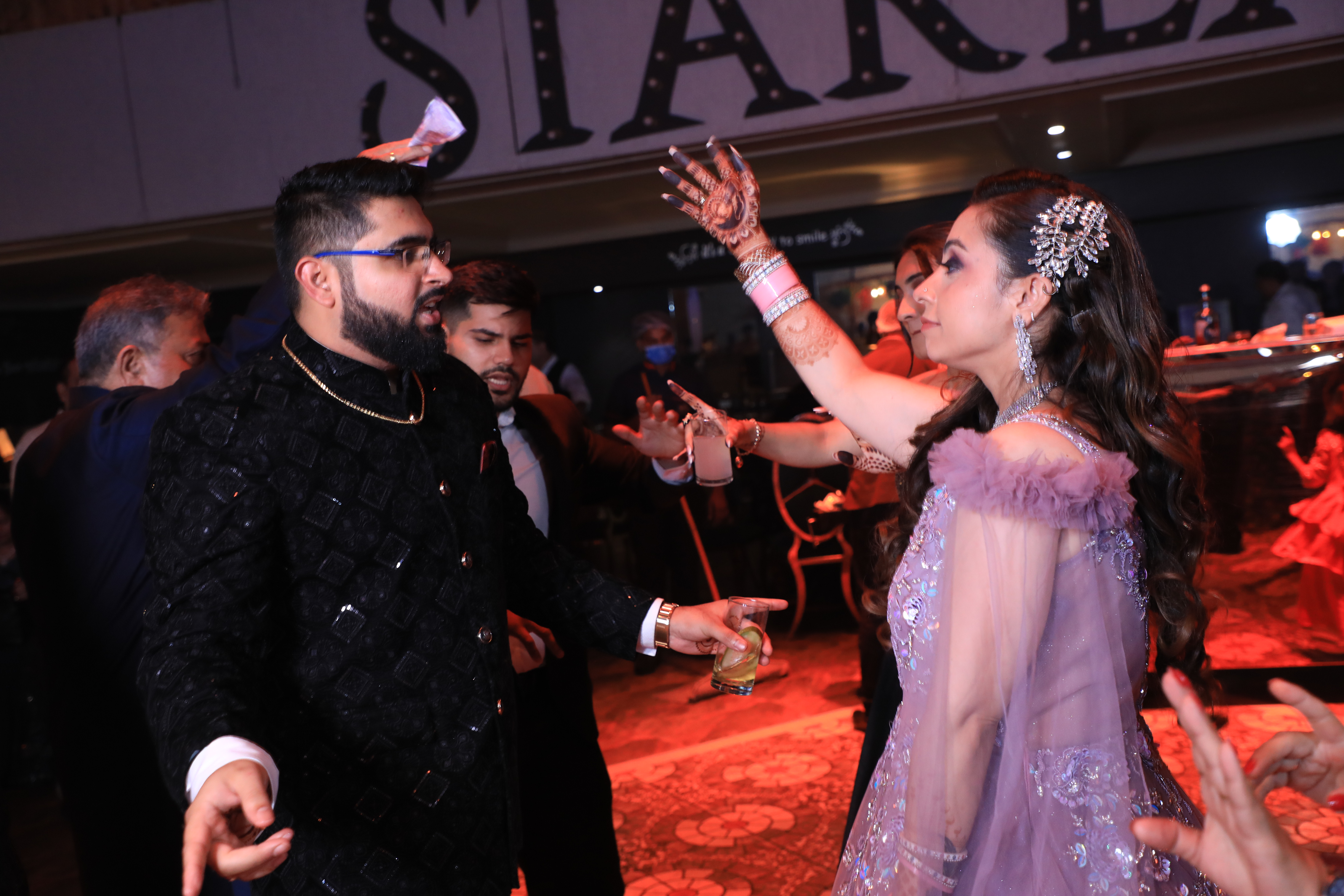 Groom dancing with family during cocktail celebration